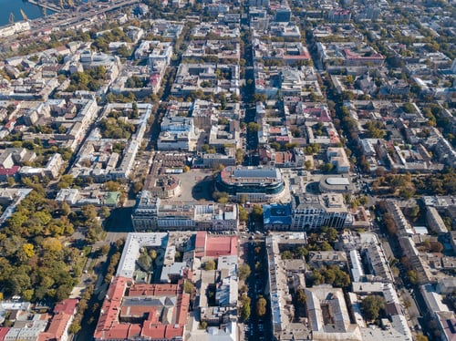 Preview: Aerial view from the drone on the shopping center, buildings and streets with cars on a sunny day