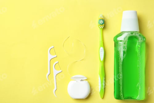 Preview: Flat lay composition with manual toothbrush and oral hygiene products on color background