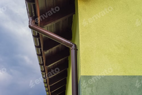 Preview: Light green house facade with visible roof soffit and gutter