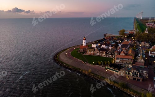 Preview: Urk Flevoland Netherlands sunset at the lighthouse and harbor of Urk Holland. Fishing village Urk