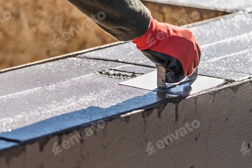Preview: Construction Worker Using Hand Groover On Wet Cement Forming Coping Around New Pool
