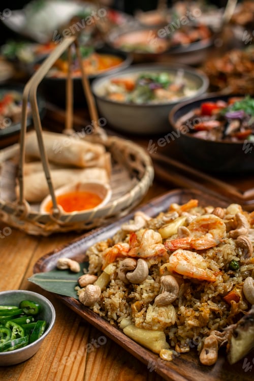 Preview: Thai chicken fried rice with pineapple and cashew on modrn bangkok restaurant table in thailand