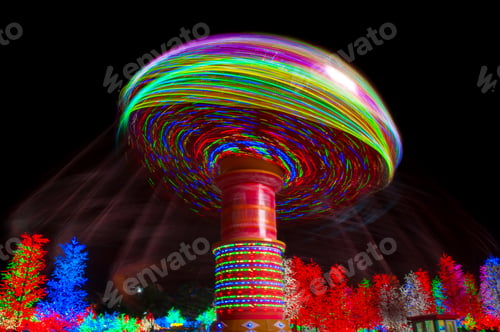 Preview: Carnival amusement park ride with swings. Spinning fair ride at night with bright color lights