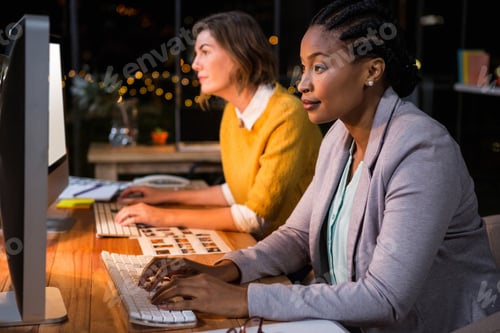 Preview: Businesswomen Working On Computer At Their Desk In The Office