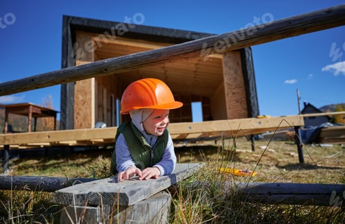 Preview: Boy toddler playing as builder on construction site