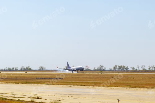 Preview: Passenger plane taking off from runway at airport on sunny day