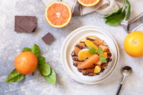 Preview: Delicious homemade american bananas pancakes with chocolate and orange.