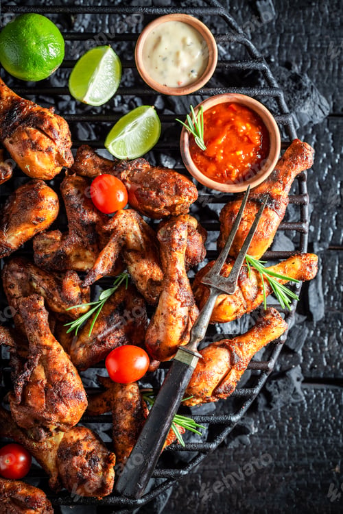 Preview: Hot and spicy roasted chicken wings on metal grate