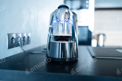 Preview: Modern professional espresso coffee machine, cup on kitchen table. Having breakfast in the morning
