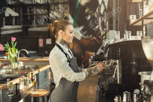 Smiling Woman Making Coffee in Cafe