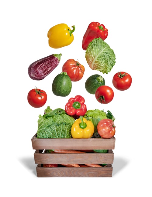 Preview: Fresh vegetables falling into wooden crate on white background