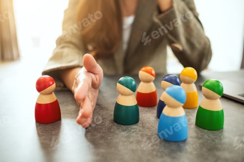 Preview: Concept image of a business woman separate one wooden people from a group
