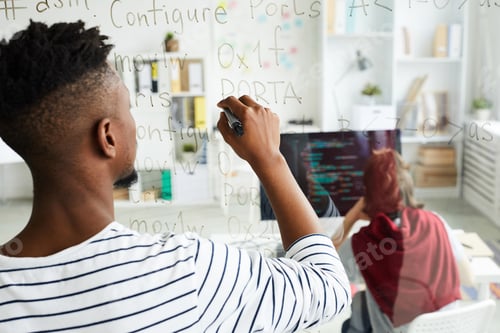 Preview: App developer writing code on glassy wall