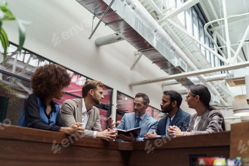 Preview: Multiethnic group of business people talking in office during break. Teamwork concept