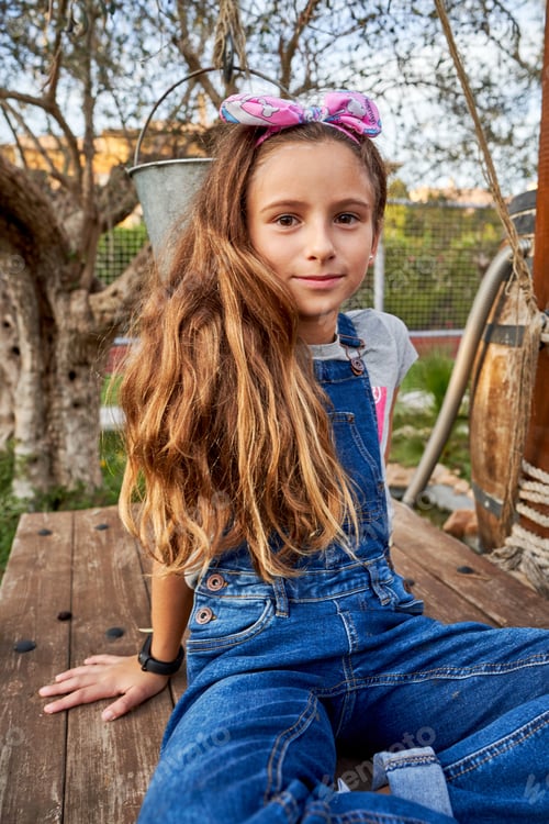 Preview: Cute girl sitting in park