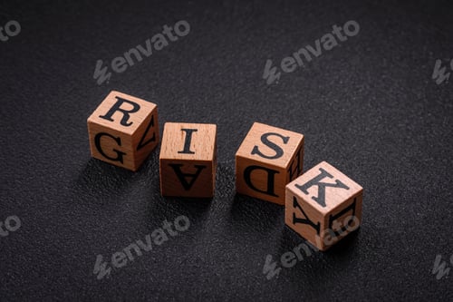 Preview: The inscription risk with wooden cubes on a dark concrete background