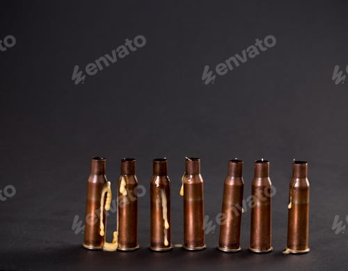 Preview: Empty rifle cartridges with melted candles.