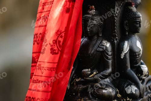 Preview: Black Buddha idol statue with red prayer flags in Durbar Square Kathmandu, Nepal