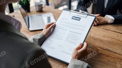 Preview: Close-up of business owner check resume of job applicants in company at the office.