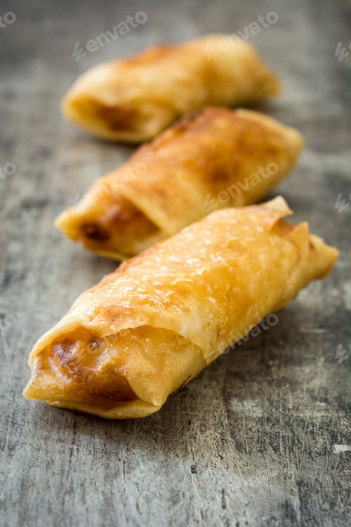 Preview: Crispy fried spring rolls arranged on rustic wooden table