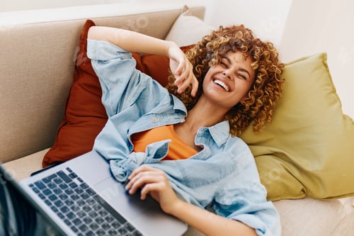 Preview: Sitting on a Sofa: A Smiling Woman's Modern Lifestyle at Home.
