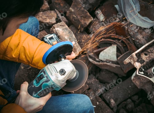 Preview: A young caucasian man in a yellow jacket is holding a drill and polishing with a disc