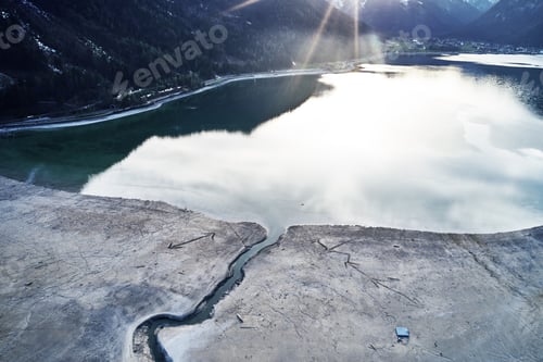 Preview: Beautiful shot of a lake with the reflection of the sky and a crack on the shore