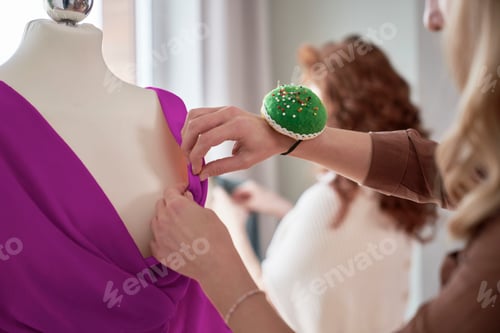 Preview: Close up of woman working about new dress in design studio