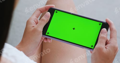 Preview: Woman watch on cellphone with chroma key inside building