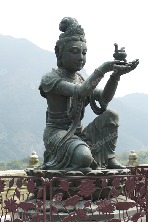 Preview: Vertical shot of a Buddha statue on a bright sky background