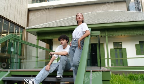 Aperçu: Young couple posing on stairs in front of green colonial building