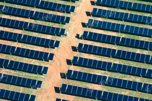 Preview: Aerial view of big sustainable electric power plant with many rows of solar photovoltaic panels