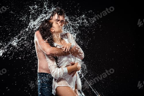 Preview: portrait of seductive couple with water splash isolated on black