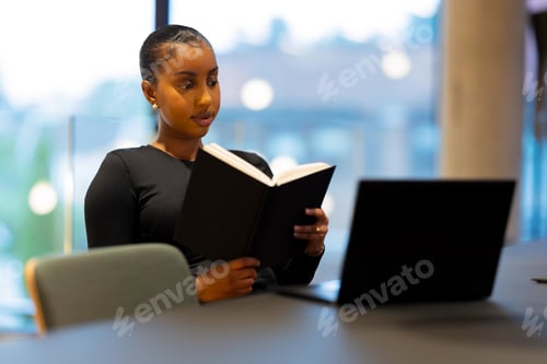 Preview: Focused student reading in library
