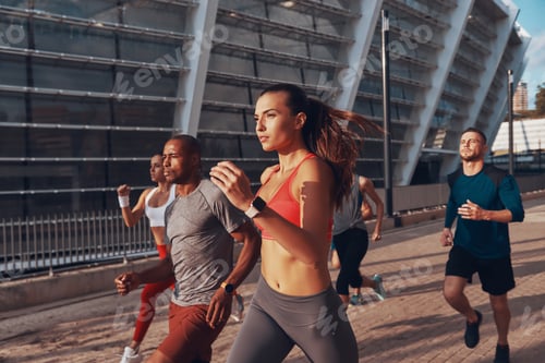 Preview: Group Of Young People In Sports Clothing Jogging Together Outdoors
