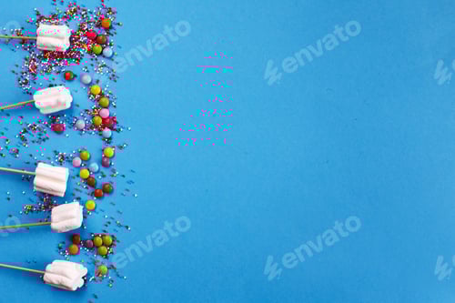 Preview: marshmallows composition with sprinkles on blue background