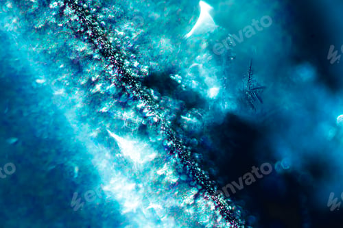 Preview: Macro shot of melting snow flowing on a windscreen