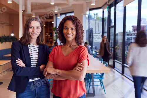 Preview: Portrait Of Two Businesswomen Standing In Modern Open Plan Office Together