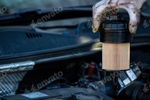 Preview: Car mechanic changing oil - model and oil motion blurred.