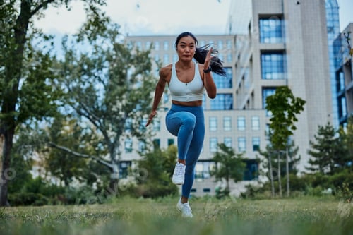 Preview: Fit young sportswoman running in the park