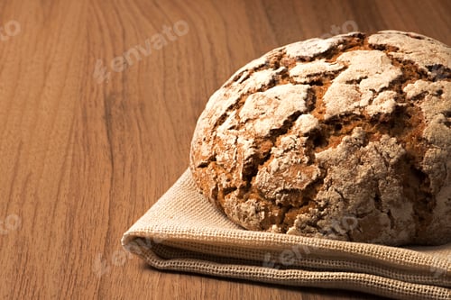 Preview: Crusty Loaf on Burlap Resting on Wooden Surface