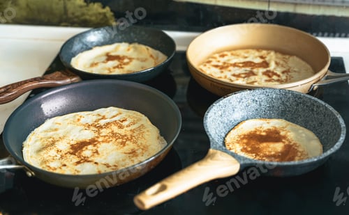 Preview: Russia Moscow 14.03.2021 Cooking many big tasty pancakes Lot of pans,oil,pancake dough.Russian