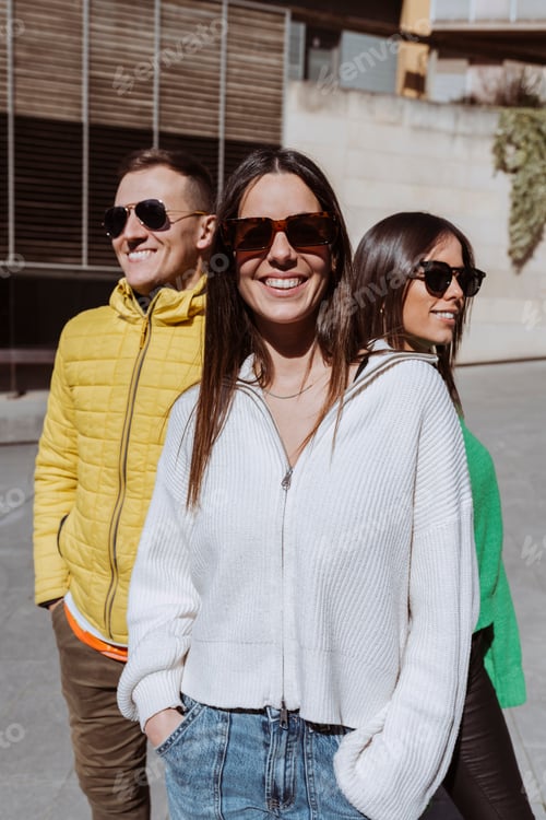 Preview: Young cheerful group of friends smiling together with sunglasses