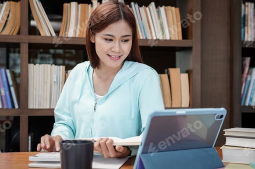 Preview: Female student is using calculator to doing homework assignment of finance and accounting