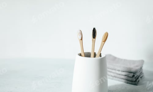 Preview: Three bamboo toothbrushes in a glass