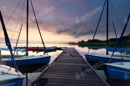 Preview: yachts on big lake harbor at sunrise