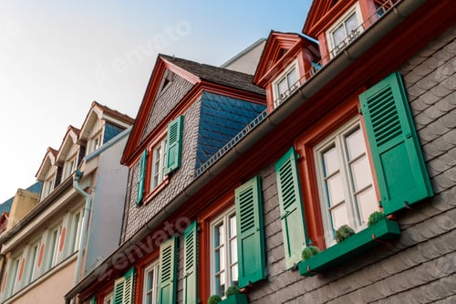 Preview: European windows with green wooden shutters in old house. Outdoors exterior