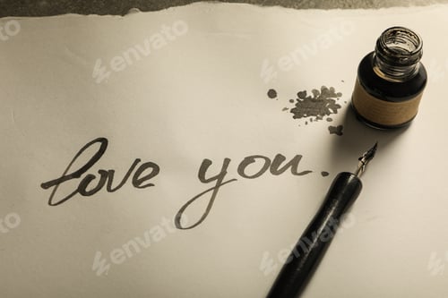 Preview: Ink bottle, pen and words Love you on paper on gray background, close up