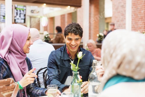 Preview: Happy friends having food at cafe in railroad station