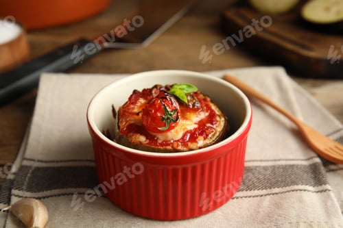 Preview: Baked eggplant with tomatoes, cheese and basil in ramekin on table, closeup